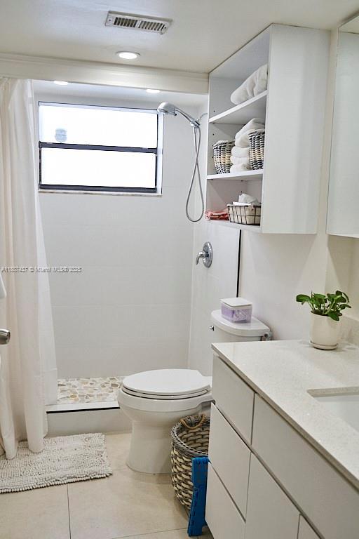 20105 NE 3rd Ct Unit 9, Miami, FL 33179 - full bath with vanity, a stall shower, toilet, and tile patterned floors