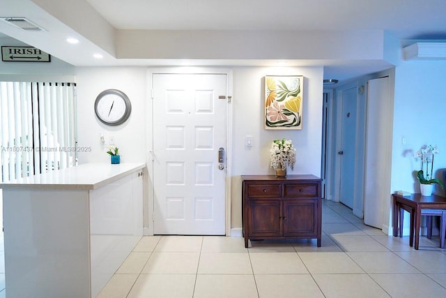 20105 NE 3rd Ct Unit 9, Miami, FL 33179 - foyer entrance with light tile patterned flooring, recessed lighting, and a wall mounted AC