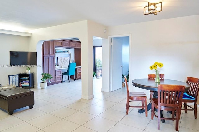 20105 NE 3rd Ct Unit 9, Miami, FL 33179 - dining room featuring arched walkways and light tile patterned floors