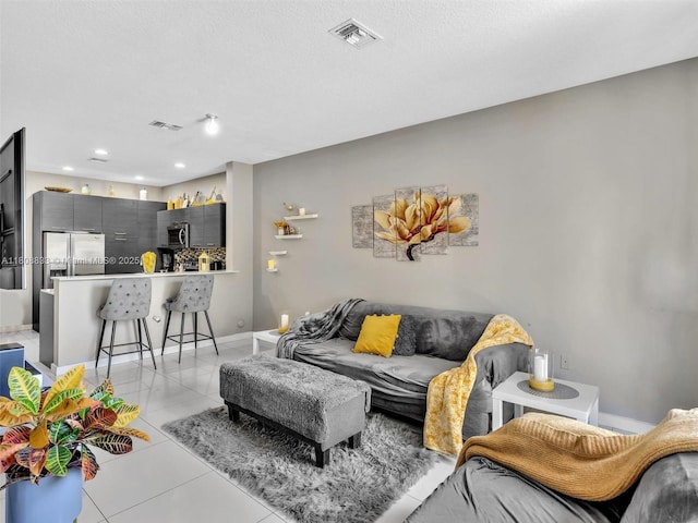 3502 NW 13th St, Lauderhill, FL 33311 - living room with light tile patterned floors, baseboards, and a textured ceiling