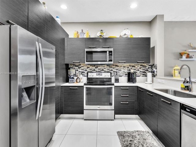 3502 NW 13th St, Lauderhill, FL 33311 - kitchen with appliances with stainless steel finishes, a sink, light tile patterned floors, modern cabinets, and backsplash