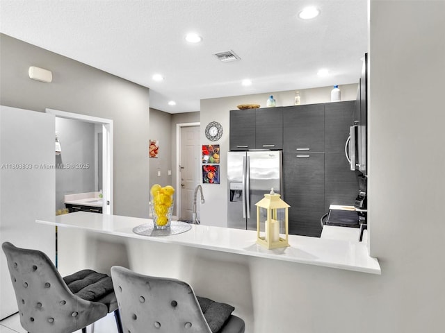 3502 NW 13th St, Lauderhill, FL 33311 - kitchen with stainless steel appliances, a breakfast bar area, recessed lighting, a peninsula, and a sink