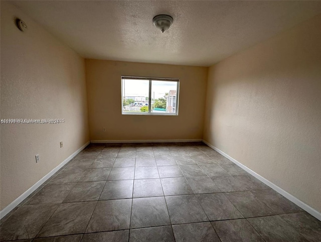 15480 SW 284th St Unit 2304, Homestead, FL 33033 - tiled spare room featuring a textured ceiling, baseboards, a smoke detector, and a textured wall