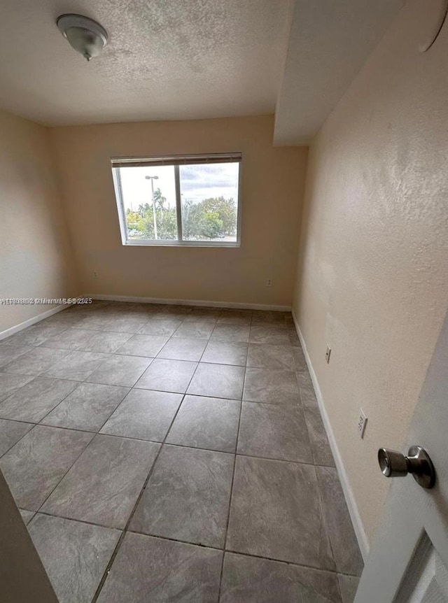 15480 SW 284th St Unit 2304, Homestead, FL 33033 - tiled empty room with baseboards and a textured ceiling