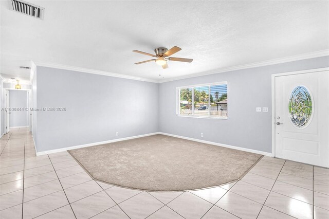 1520 N 25th Ave, Hollywood, FL 33020 - entryway with ornamental molding, a ceiling fan, light tile patterned floors, baseboards, and light colored carpet