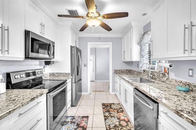 1520 N 25th Ave, Hollywood, FL 33020 - kitchen featuring stainless steel appliances, a sink, white cabinetry, a ceiling fan, and light stone counters