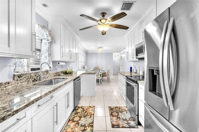 1520 N 25th Ave, Hollywood, FL 33020 - kitchen featuring stainless steel appliances, a sink, crown molding, ceiling fan, and white cabinetry