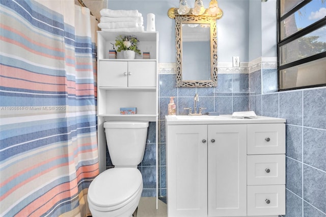 1520 N 25th Ave, Hollywood, FL 33020 - bathroom with tile walls, toilet, vanity, a shower with curtain, and a wainscoted wall