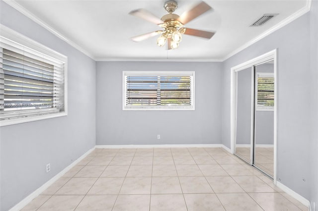 1520 N 25th Ave, Hollywood, FL 33020 - empty room with healthy amount of natural light, ceiling fan, ornamental molding, light tile patterned flooring, and baseboards