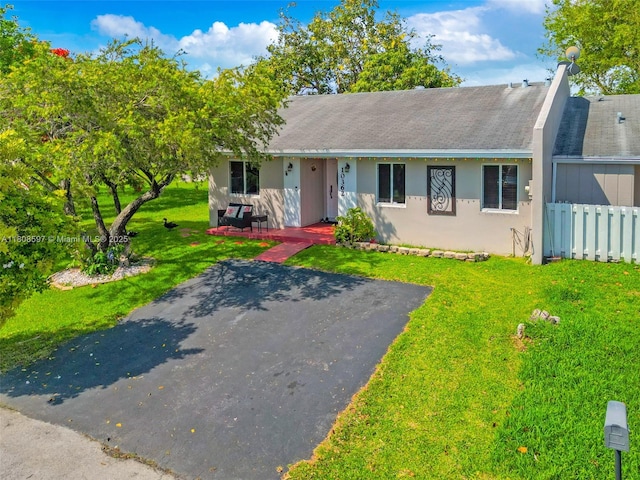 10362 SW 208th Ln, Cutler Bay, FL 33189 - view of front of home featuring a front lawn, stucco siding, roof with shingles, and covered porch