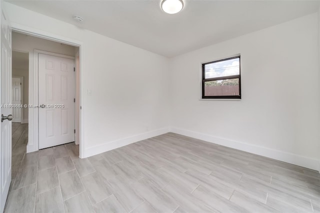 2447 Fletcher St, Hollywood, FL 33020 - empty room with a smoke detector, baseboards, and light wood-style flooring