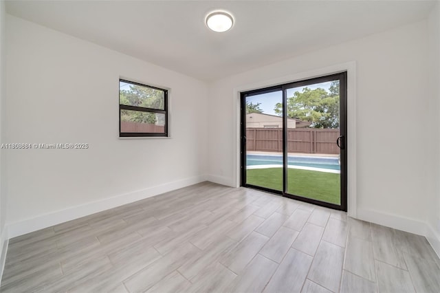 2447 Fletcher St, Hollywood, FL 33020 - unfurnished room featuring healthy amount of natural light, light wood-style flooring, and baseboards