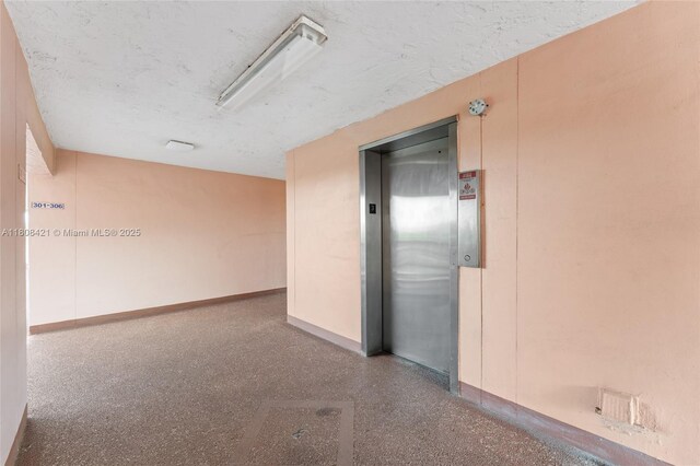 9401 Sunrise Lakes Blvd Unit 307, Sunrise, FL 33322 - empty room with elevator, baseboards, and speckle patterned floor