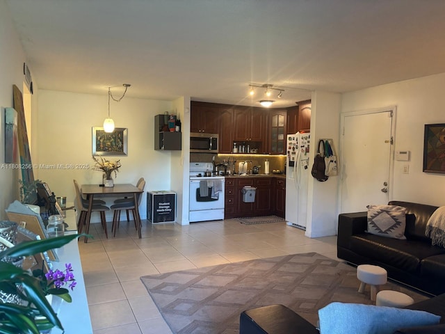 771 NE 199th St Unit 103, Miami, FL 33179 - living area with light tile patterned floors and rail lighting