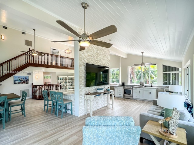 168 Indian Mound Trl, Tavernier, FL 33070 - living room featuring ceiling fan, light wood-type flooring, lofted ceiling, and stairway