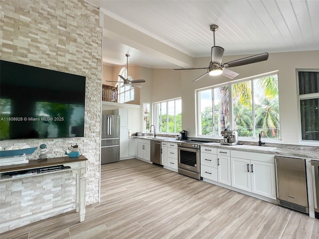 168 Indian Mound Trl, Tavernier, FL 33070 - kitchen featuring stainless steel appliances, ceiling fan, a sink, ornamental molding, and white cabinets