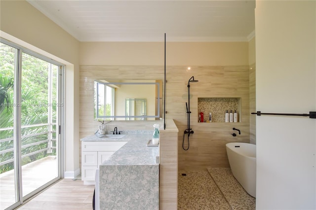 168 Indian Mound Trl, Tavernier, FL 33070 - full bath with vanity, a freestanding bath, a walk in shower, tile walls, and crown molding