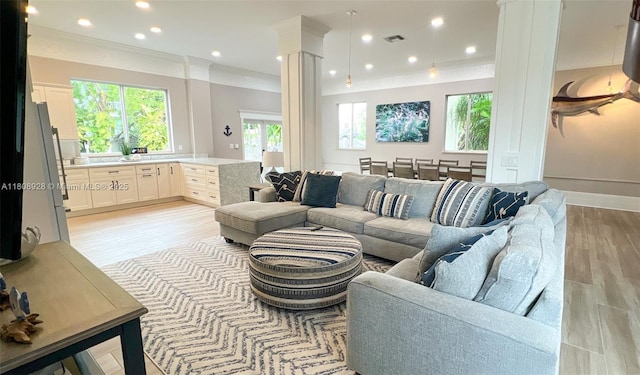 168 Indian Mound Trl, Tavernier, FL 33070 - living room with decorative columns, healthy amount of natural light, light wood-style flooring, ornamental molding, and recessed lighting