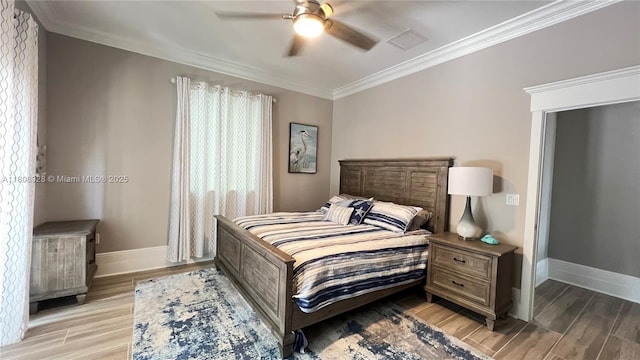 168 Indian Mound Trl, Tavernier, FL 33070 - bedroom with baseboards, ornamental molding, light wood-style floors, and a ceiling fan
