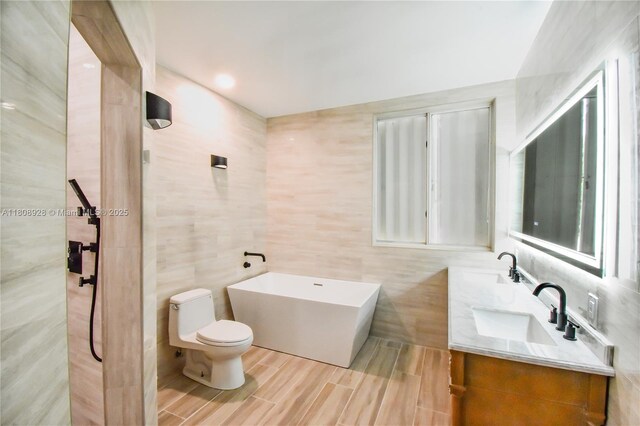 168 Indian Mound Trl, Tavernier, FL 33070 - full bath with tile walls, toilet, double vanity, a soaking tub, and tasteful backsplash