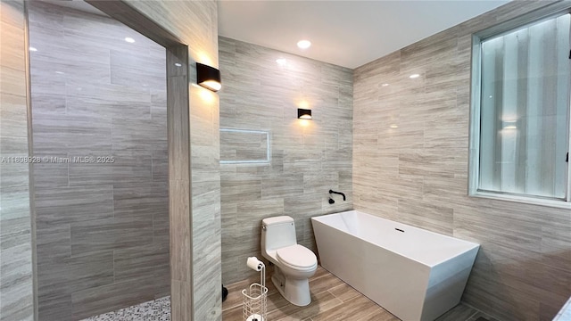 168 Indian Mound Trl, Tavernier, FL 33070 - bathroom featuring tile walls, toilet, and a freestanding tub