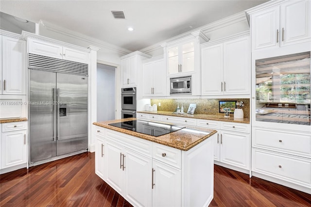169 Dockside Cir, Weston, FL 33327 - kitchen with built in appliances, a center island, dark wood-style flooring, decorative backsplash, and white cabinetry