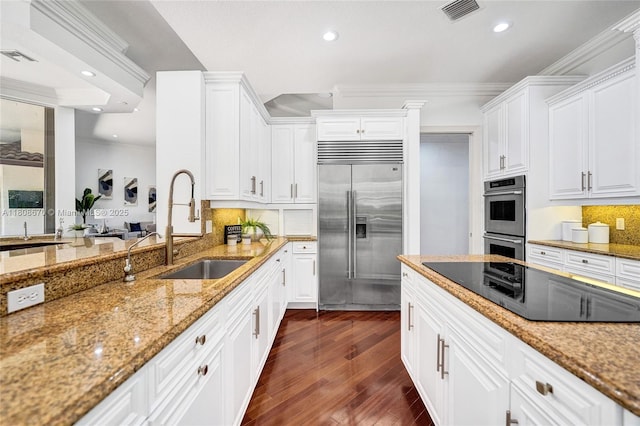 169 Dockside Cir, Weston, FL 33327 - kitchen featuring stainless steel appliances, a sink, recessed lighting, dark wood-style floors, and light stone countertops