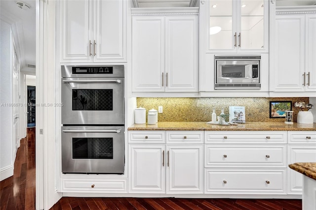 169 Dockside Cir, Weston, FL 33327 - kitchen featuring stainless steel appliances, white cabinetry, light stone countertops, glass insert cabinets, and dark wood finished floors