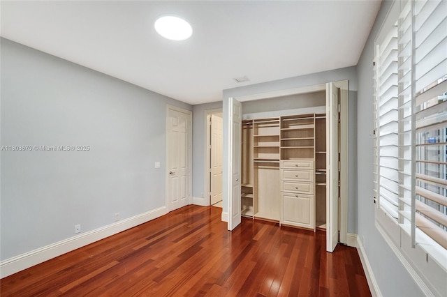 169 Dockside Cir, Weston, FL 33327 - unfurnished bedroom featuring dark wood-type flooring, baseboards, and multiple windows