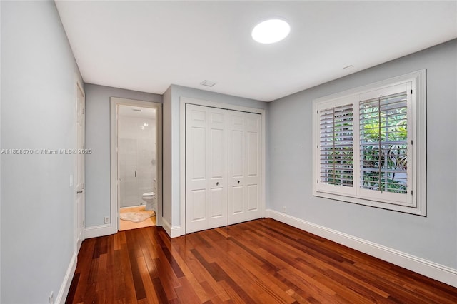 169 Dockside Cir, Weston, FL 33327 - unfurnished bedroom featuring wood finished floors, baseboards, and a closet