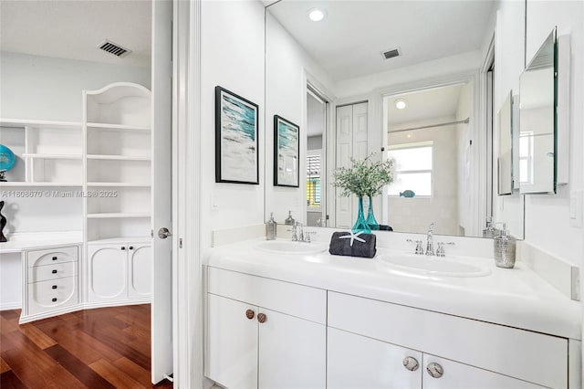 169 Dockside Cir, Weston, FL 33327 - bathroom featuring double vanity, wood finished floors, and recessed lighting