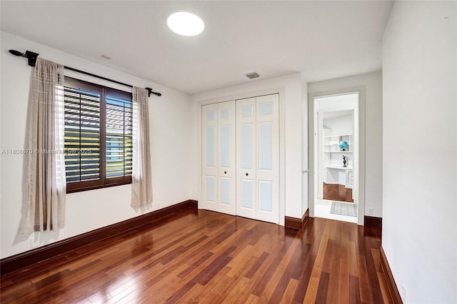 169 Dockside Cir, Weston, FL 33327 - unfurnished bedroom with wood finished floors, baseboards, and a closet