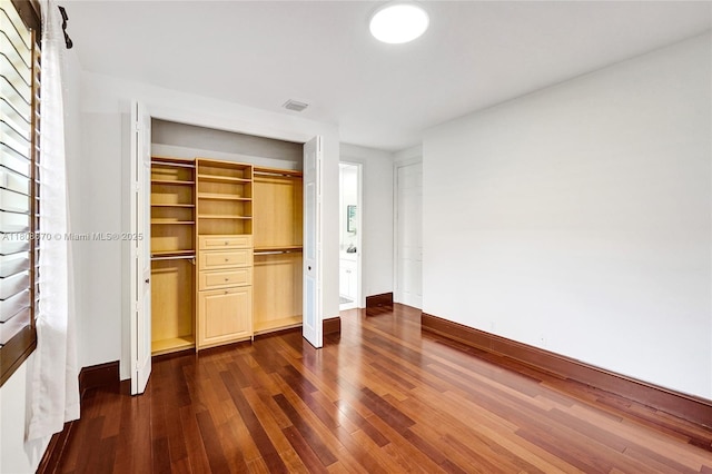 169 Dockside Cir, Weston, FL 33327 - unfurnished bedroom featuring dark wood-type flooring, baseboards, and a closet