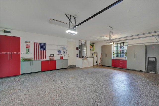 169 Dockside Cir, Weston, FL 33327 - garage featuring water heater and a garage door opener