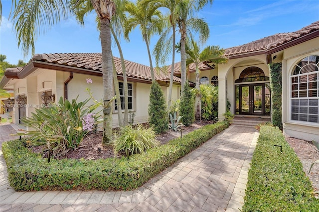169 Dockside Cir, Weston, FL 33327 - entrance to property featuring french doors, a tiled roof, and stucco siding