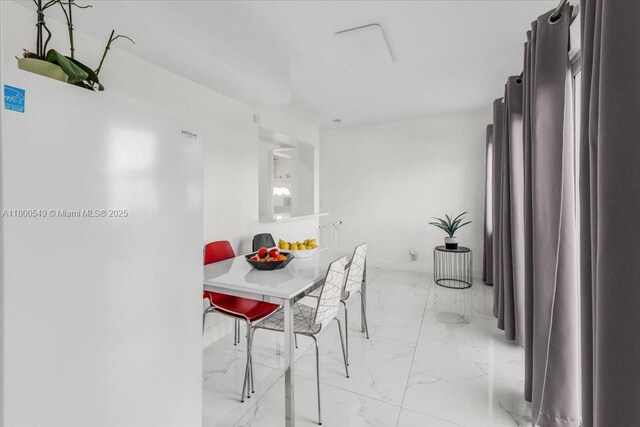 4340 NW 19th Ave, Oakland Park, FL 33309 - dining space featuring light marble finish floors