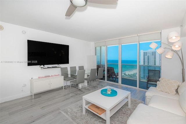 1830 S Ocean Dr Unit 1605, Hallandale Beach, FL 33009 - living room with expansive windows, wood finished floors, and ceiling fan