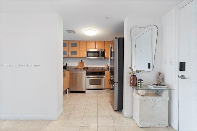 2101 Brickell Ave Unit 1702, Miami, FL 33129 - kitchen featuring stainless steel appliances, glass insert cabinets, and baseboards