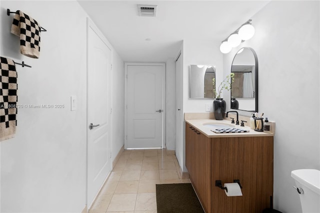 2101 Brickell Ave Unit 1702, Miami, FL 33129 - bathroom featuring vanity, toilet, and tile patterned floors