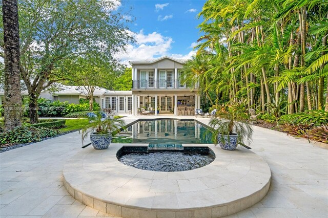 7360 SW 164th St, Palmetto Bay, FL 33157 - rear view of house with french doors, a balcony, a patio area, and a pool with connected hot tub