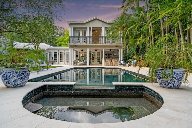 7360 SW 164th St, Palmetto Bay, FL 33157 - back of property featuring french doors, a balcony, a ceiling fan, a patio, and a pool with connected hot tub