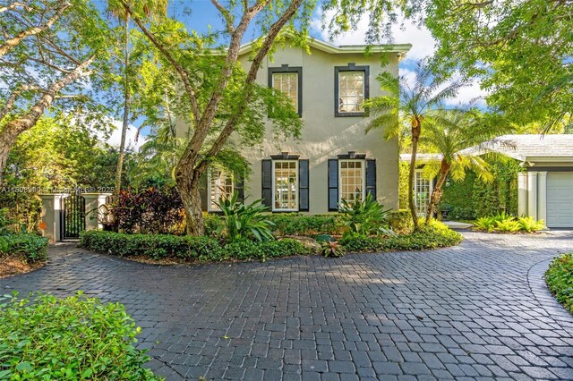 7360 SW 164th St, Palmetto Bay, FL 33157 - view of front of property featuring stucco siding, decorative driveway, and a gate