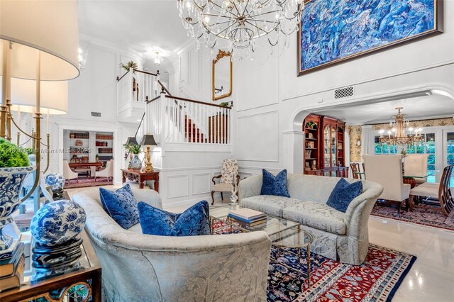 7360 SW 164th St, Palmetto Bay, FL 33157 - living room featuring a chandelier, a towering ceiling, stairs, marble tiled flooring, and crown molding