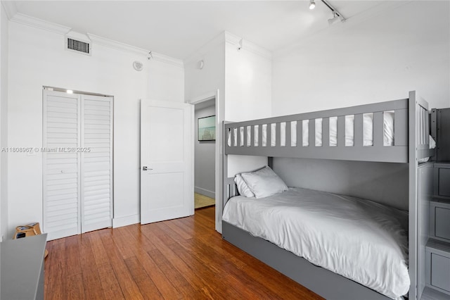 201 Crandon Blvd Unit 1030, Key Biscayne, FL 33149 - bedroom with ornamental molding, wood finished floors, and track lighting