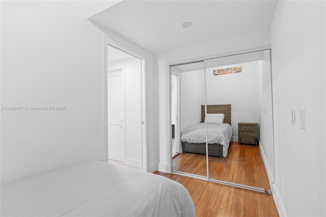 201 Crandon Blvd Unit 1030, Key Biscayne, FL 33149 - bedroom featuring wood finished floors, a closet, and baseboards