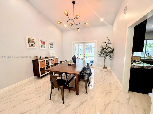 14870 SW 152nd Ct, Miami, FL 33196 - dining area with light marble finish flooring, a chandelier, baseboards, and high vaulted ceiling