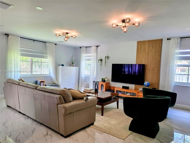 14870 SW 152nd Ct, Miami, FL 33196 - living area with healthy amount of natural light, light marble finish floors, and baseboards