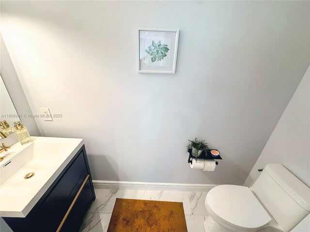 14870 SW 152nd Ct, Miami, FL 33196 - bathroom featuring marble finish floors, vanity, toilet, and baseboards