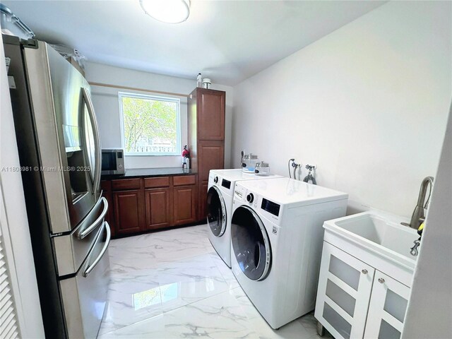 14870 SW 152nd Ct, Miami, FL 33196 - washroom featuring light marble finish flooring, separate washer and dryer, and cabinet space
