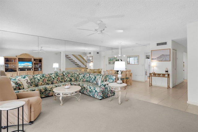 601 W Ocean Dr Dr Unit 411C, Key Colony, FL 33051 - tiled living room featuring ceiling fan, carpet, a textured ceiling, and stairway